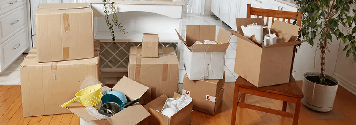 Packed moving boxes and household items in a kitchen before move-out or move-in cleaning, Sacramento, CA.